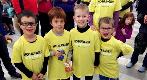 A group of kids wearing "No Hunger November" shirts