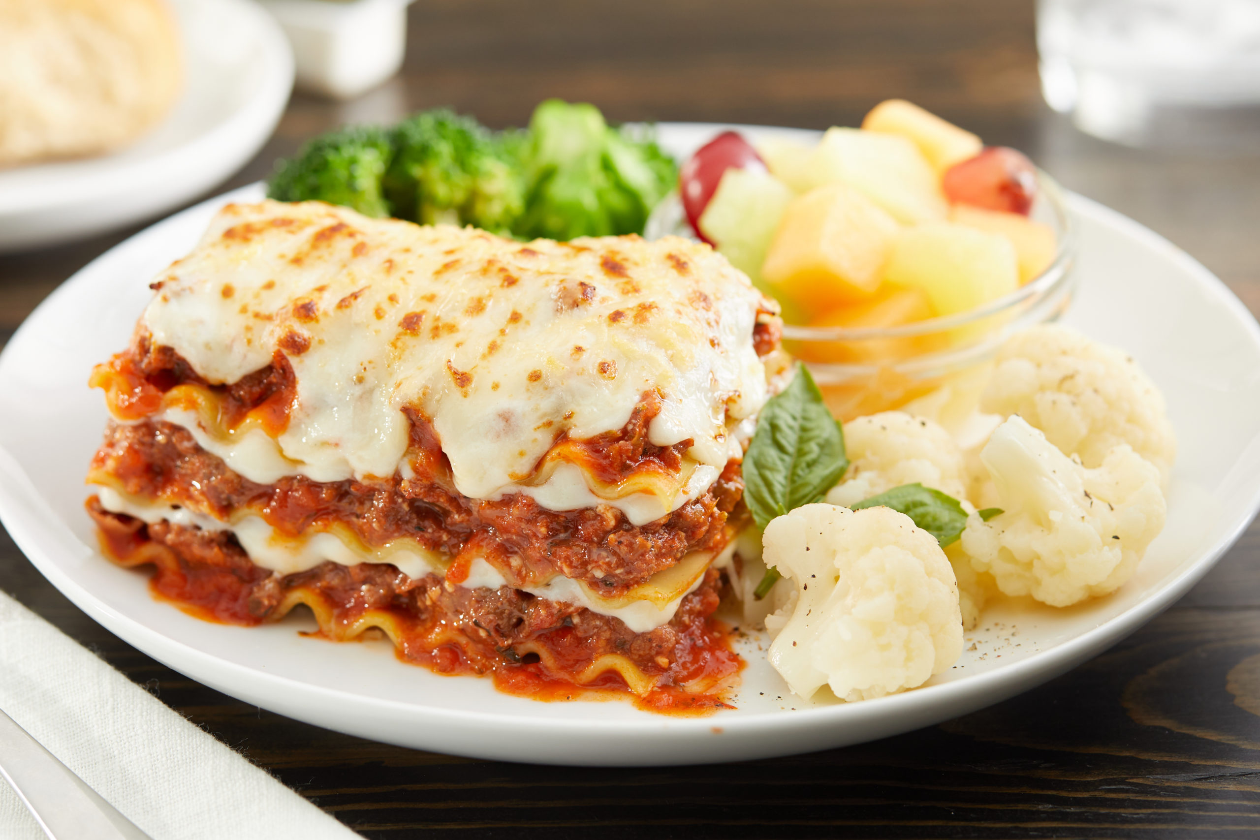 Lasagna meal with fruit and veggies