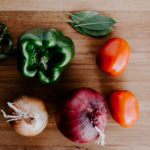 Fresh vegetables on a cutting board with a knife. Learn how Minnesota EBT benefits can help you get the benefits of Meals on Wheels.