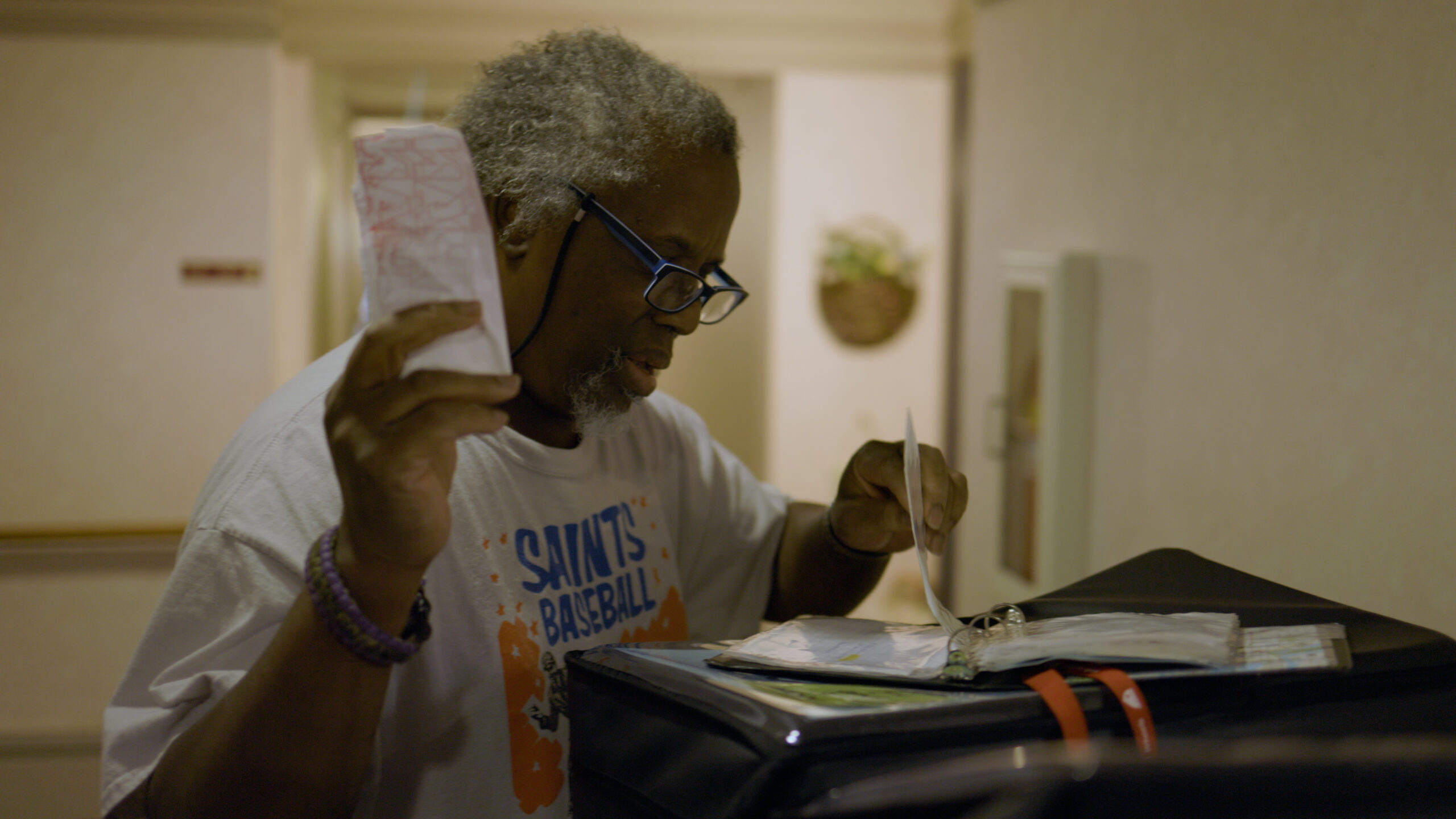 Andre Minor looks over his route sheet while delivering meals