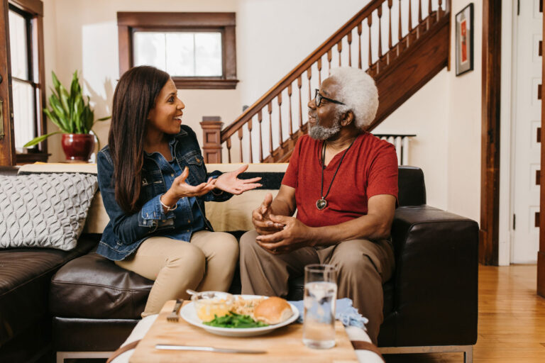 Father and daughter chatting and enjoying a meal